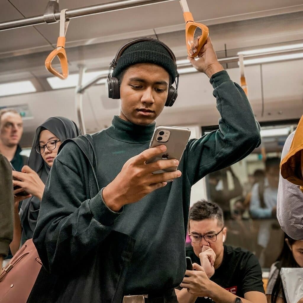 Passenger checking phone in a train