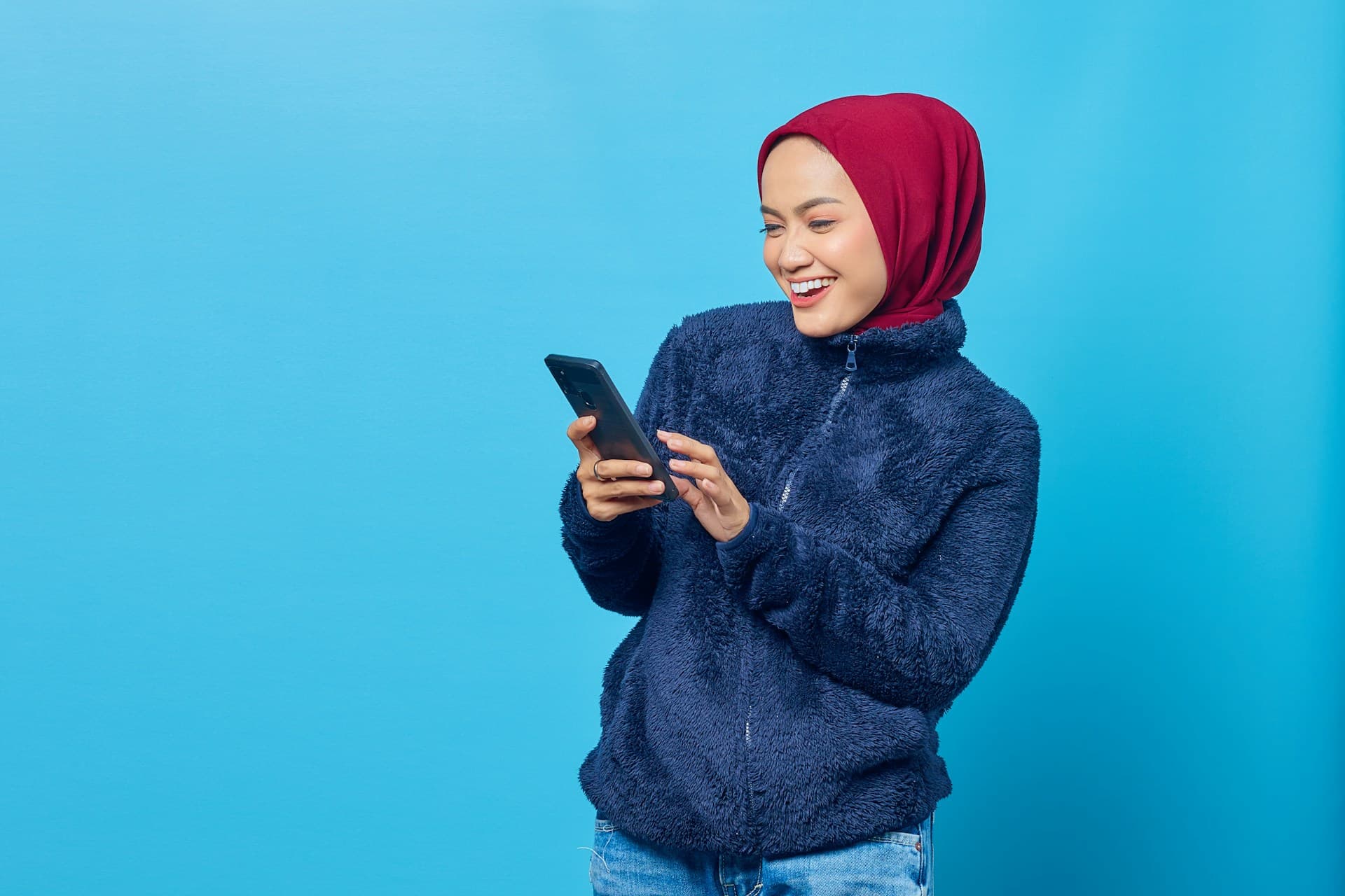 Woman smiling while using a phone